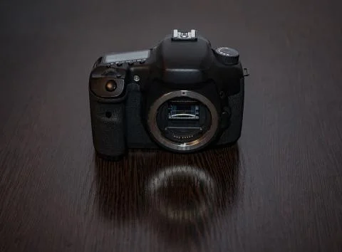 A digital SLR camera lies on a table 스톡 사진
