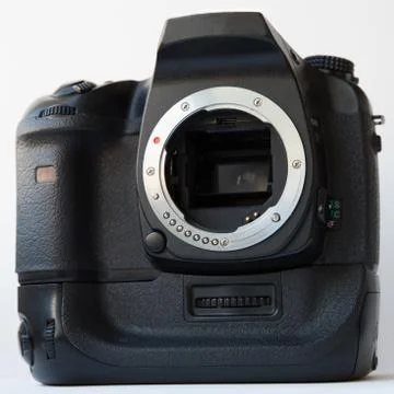 Digital SLR camera with vertical battery grip over white background Stock Photos
