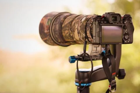 Digital slr or mirrorless camera with camouflage cover for shooting of nature Stock Photos