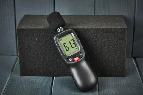 Digital sound level meter with display and control buttons on acoustic foam Stock Photos