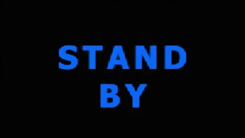 Digital standby text with glowing blue heart logo during dark cinematic motio Video stock 343415328