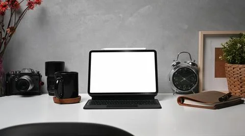Digital table with wireless keyboard, camera, coffee cup and picture frame on Stock Photos