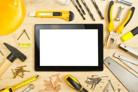 Digital Tablet and Assorted Carpentry Tools  on Workshop Table Stock Photos