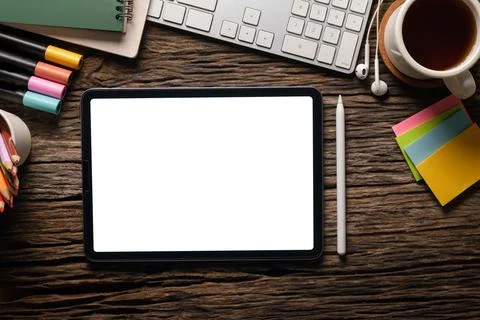 Digital tablet with blank screen, coffee cup, stationery and keyboard on wo.. Stock Photos