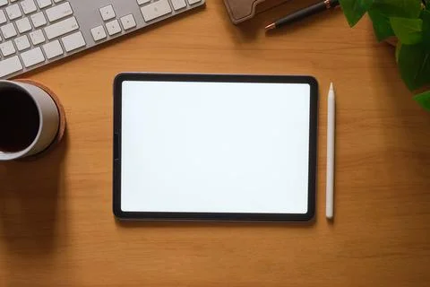 Digital tablet with blank screen, coffee cup, stationery and keyboard on wo.. Stock Photos