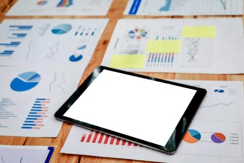 Digital tablet with blank screen  on  financial graphs and charts Stock Photos