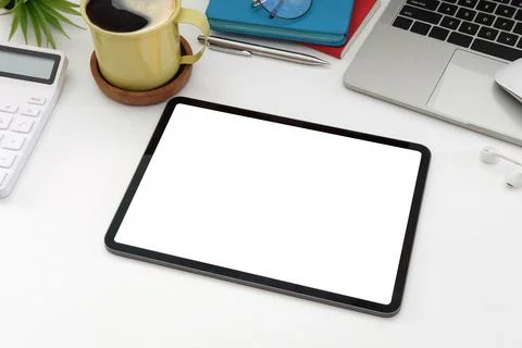 Digital tablet with blank screen, laptop computer, calculator and coffee cup  Stock Photos
