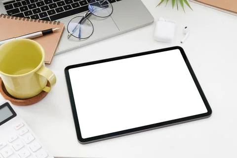 Digital tablet with blank screen, laptop computer, calculator and coffee cup  Stock Photos