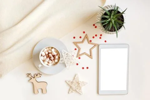 A digital tablet with a blank screen lies on a white table surrounded by flat Stock Photos