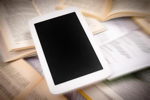 Digital tablet on books Stock Photos