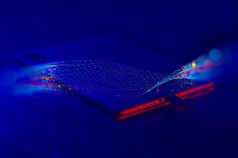 Digital tablet with a cable charges on the background with abstract technol.. Stock Photos