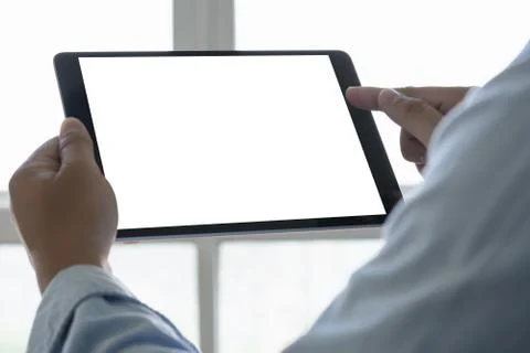 Digital tablet computer close up man using tablet hands man multitasking with Foto stock