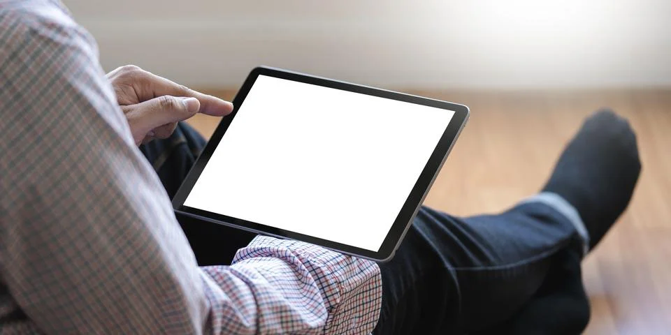 Digital tablet computer close up man using tablet hands man multitasking with 写真素材