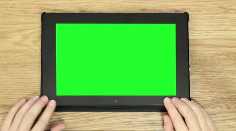 Digital tablet computer with isolated green screen on wooden table, top view HD Stock Footage 49399020