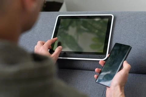 Digital tablet computer with isolated screen in male hands over cafe background Stock Photos