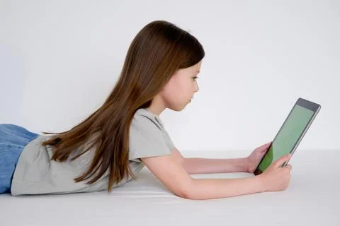 Digital tablet with empty black screen. Young girl holding tablet pc in her h Stock Photos
