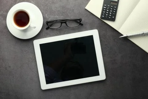 Digital tablet with empty screen and notepad on office desk Stock Photos