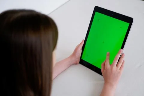 Digital tablet with empty screen. Young girl holding tablet in her hands wi.. Stock Photos