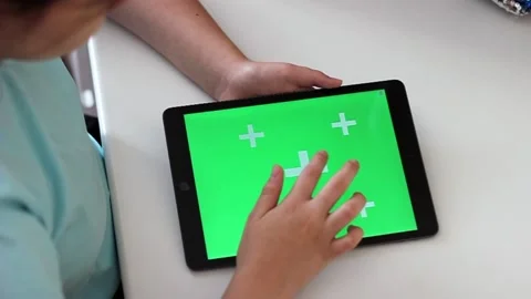 A digital tablet with a green chromakey screen lies on a white table Stock Footage 161827112
