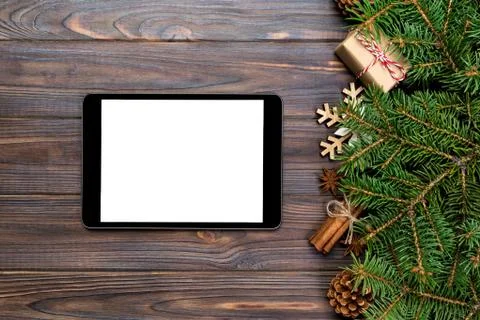 Digital tablet mock up with rustic Christmas wood background decorations for Stock Photos