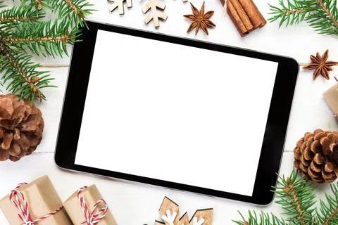 Digital tablet mock up with rustic Christmas wooden background decorations fo Stock Photos