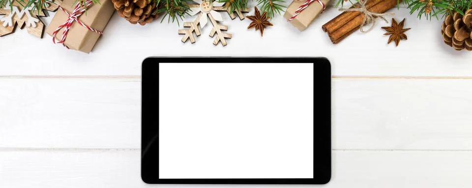 Digital tablet mock up with rustic Christmas wooden background decorations .. Stock Photos