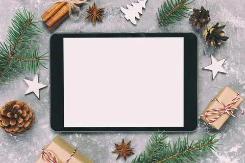 Digital tablet mock up with rustic Christmas gray cement background decorat.. Stock Photos