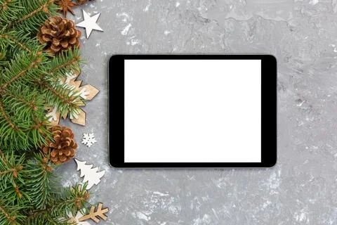 Digital tablet mock up with rustic Christmas gray cement background decorat.. Stock Photos