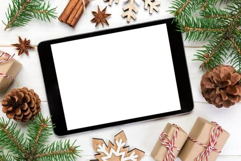 Digital tablet mock up with rustic Christmas wooden background decorations .. Stock Photos