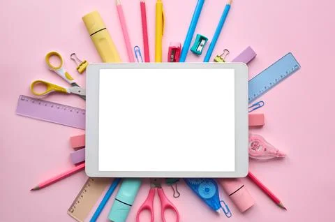 Digital tablet mock up template screen on school stationery pink background. Stock Photos