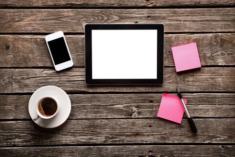 Digital tablet with note paper and cup of coffee Stock Photos