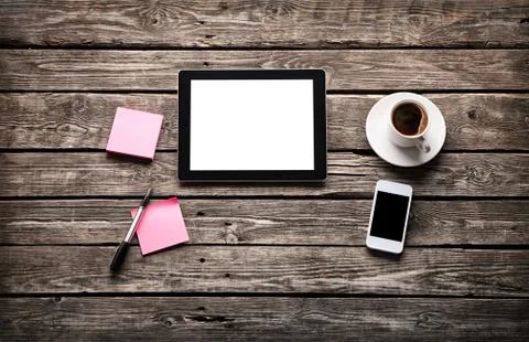 Digital tablet with note paper and cup of coffee Stock Photos