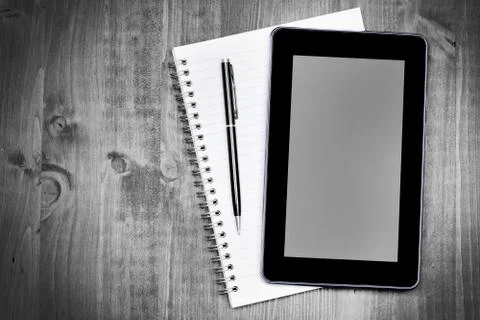 Digital tablet pc and notebook on desk Stock Photos