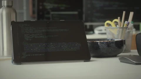 Digital Tablet with Programming Code on Desk in Office Stock Footage 263727380