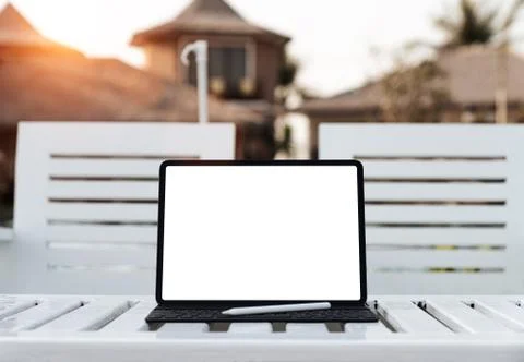 Digital tablet white screen on table at sunset Stock Photos