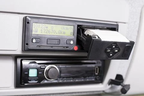 Digital tachograph with open printer and visible roll of paper. Car radio bel Stock Photos