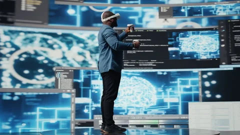 Digital tech expert coding and using VR headset at innovation hub Stock Footage 312479000