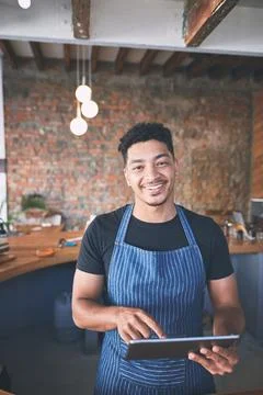 Digital tech makes managing my business so much easier. a confident young man Stock Photos