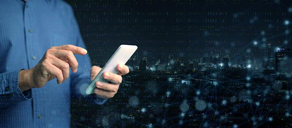 Digital technology concept. A man using his smartphone to connect and acces.. Stock Photos