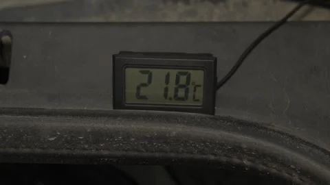 A digital thermometer displays a temperature reading of twenty-three degrees. Stock Footage 341335612