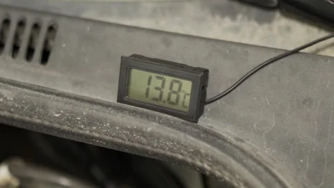 A digital thermometer displays a temperature reading of twenty-three degrees. Stock Footage 341335718