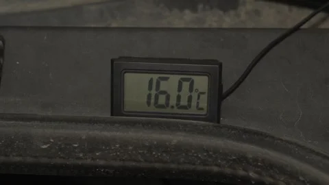 A digital thermometer displays a temperature reading of twenty-three degrees. Stock Footage 341335748