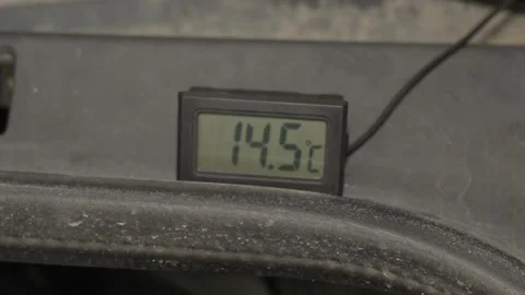 A digital thermometer displays a temperature reading of twenty-three degrees. Stock Footage 341335935