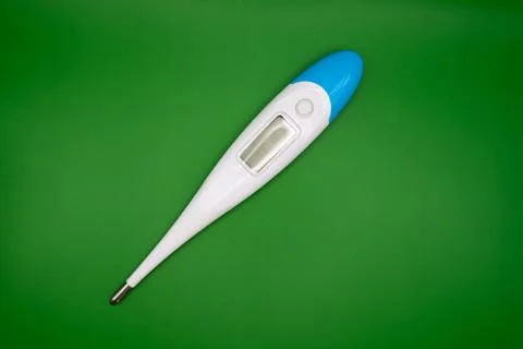 Digital thermometer on green background Stock Photos