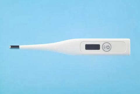 Digital thermometer levitating on a blue background. Electronic thermometer. Stock Photos