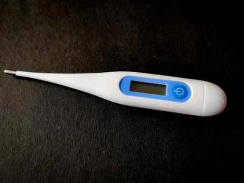 Digital Thermometer for measuring temperature. Isolated on black background. Stock Photos