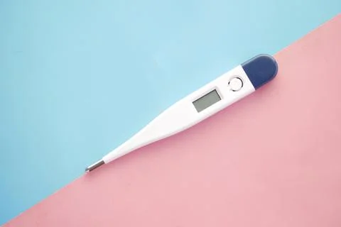 Digital thermometer on pink background with copy space Stock Photos
