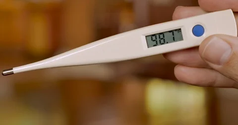 Digital thermometer reading 98.7 degrees fahrenheit - normal temperature Stock Footage 92735962