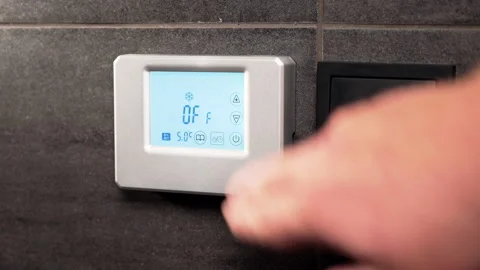 Digital thermostat with LCD display being turned off Stock Footage 201261079