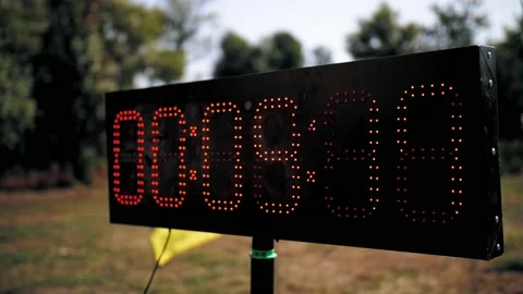 Digital timer. Counter. close-up. black light board, with red numbers of small Vidéo 165594457